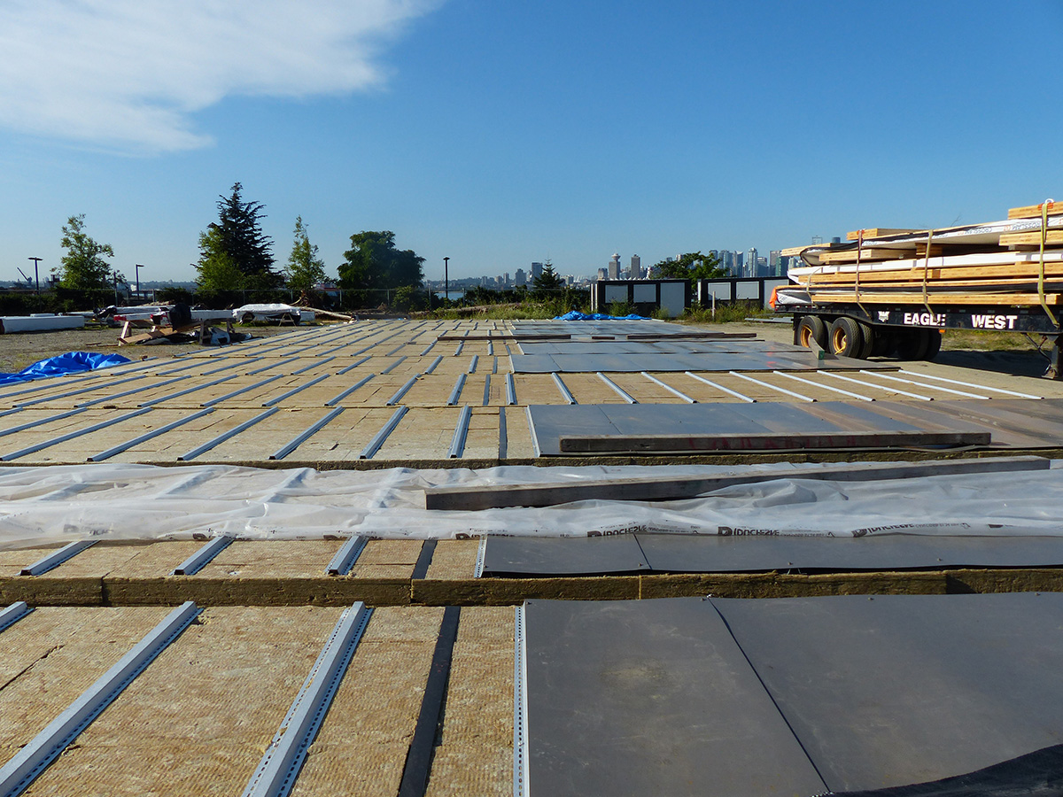 Naikoon laydown yard with multiple wood panels laying horizontally