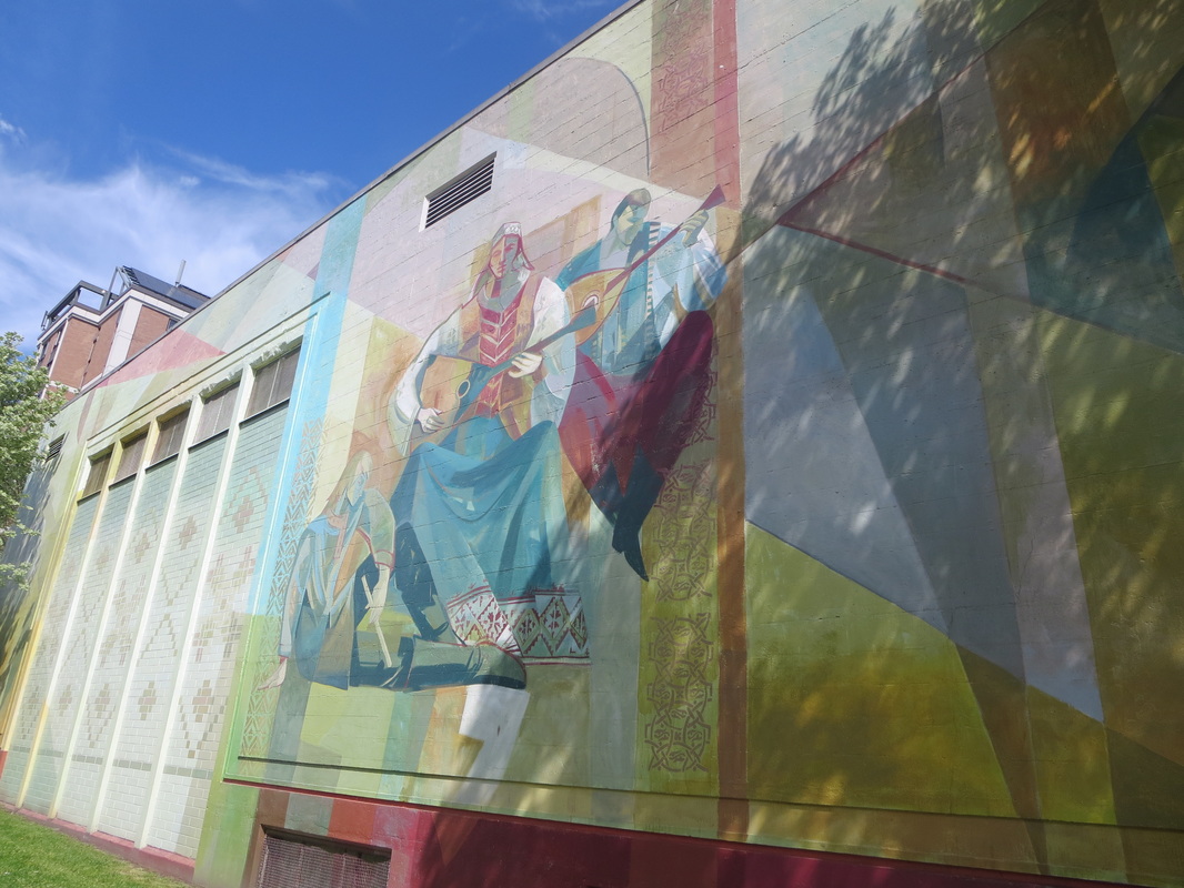 Colourful mural on exterior of building depicting folk musicians